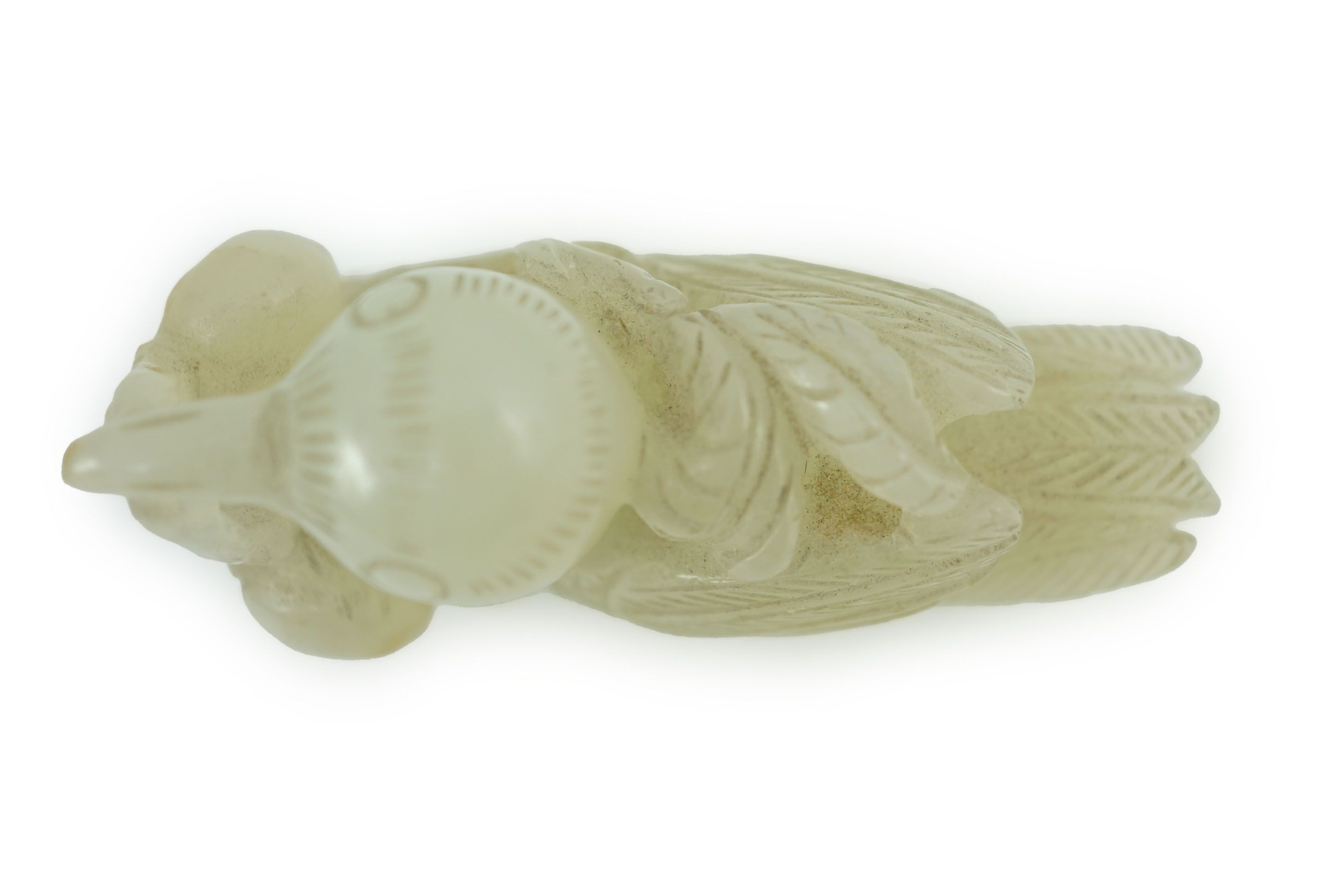 A Chinese pale celadon jade figure of a bird grasping a fruit sprig, 18th/19th century, 5.1 cm long